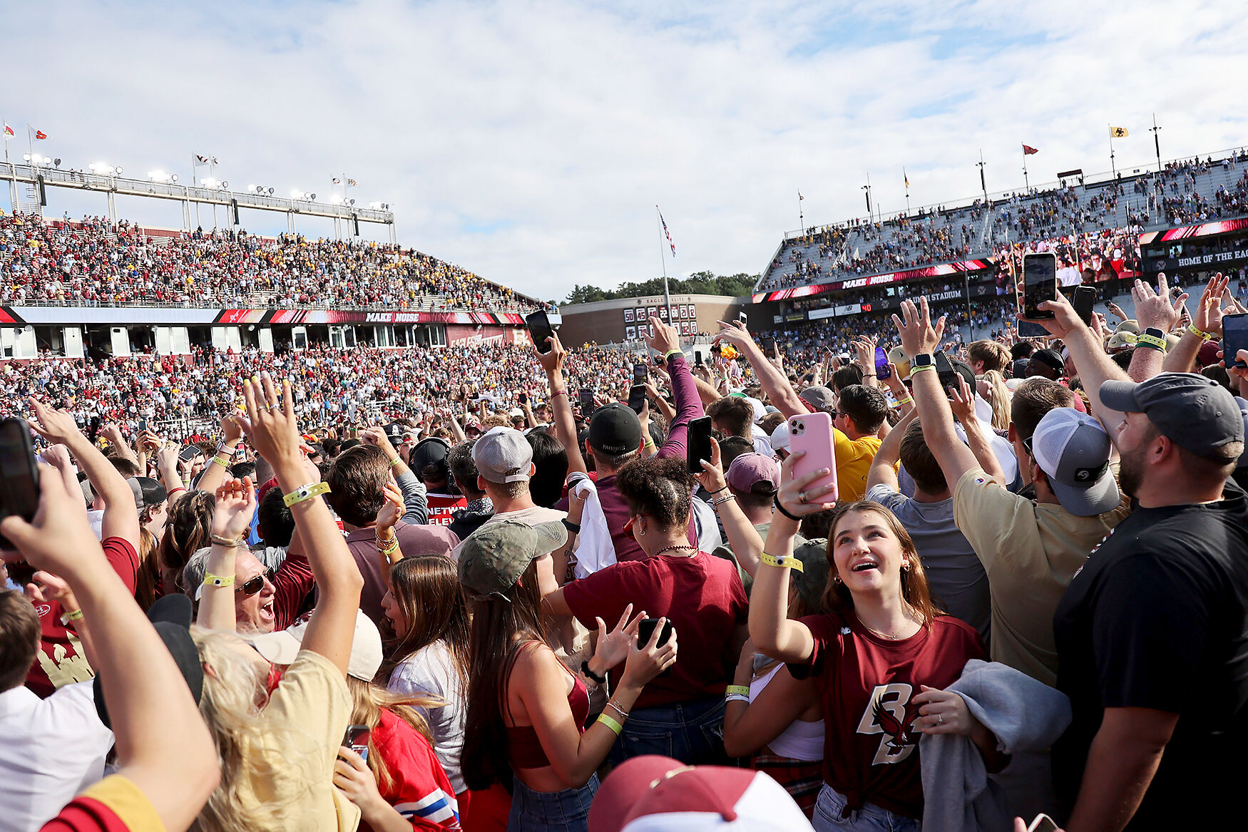 Boston College fans celebrate on the field